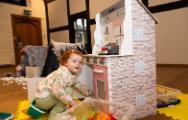 Little girl using a play kitchen