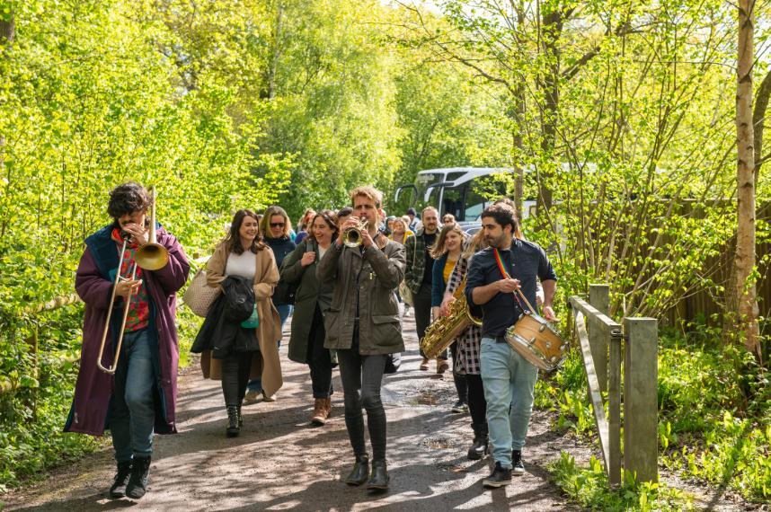 The Open Doors and National Civil War Centre teams being led by visiting musicians in a park during a staff away day.